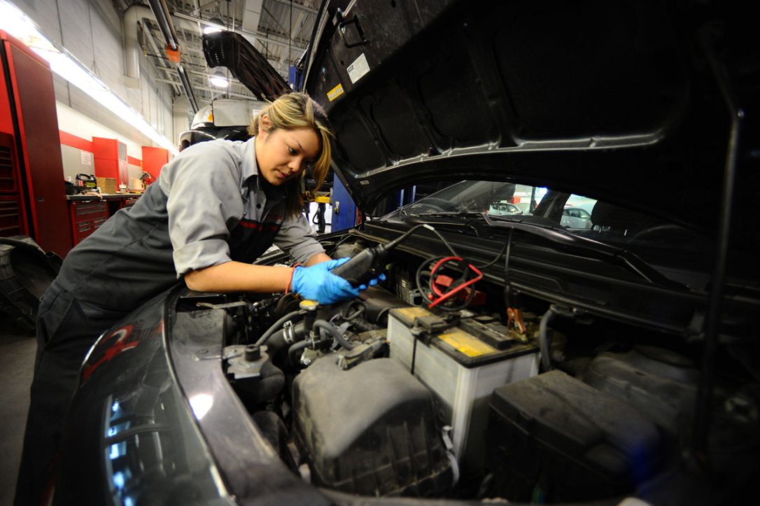 This is an image of a mechanic inspecting a vehicle.