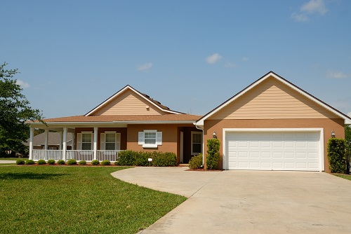 Image of a detached house in a neighbourhood with a front lawn.