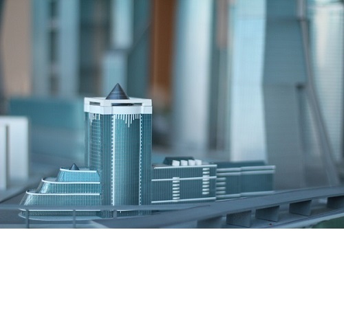 This is an image of a model of a home being held in someone’s hands.