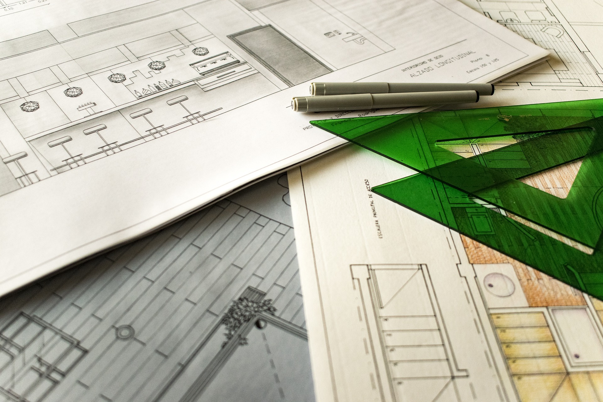 An image of design sketches, a pencil and right angled rulers required for design.