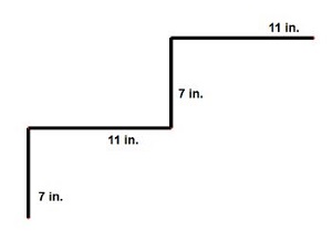 A side view of stairs showing the 7 inch rise and the 11 inch run.