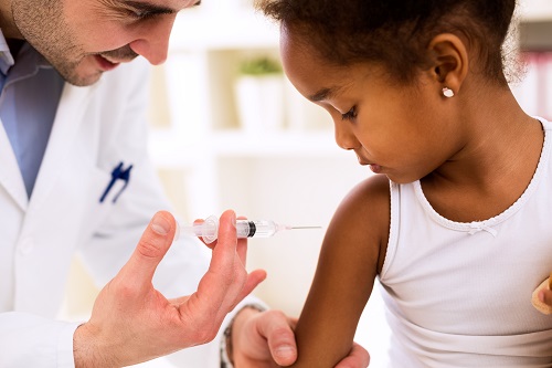 This is a picture of a doctor who is giving a vaccine to a young child.