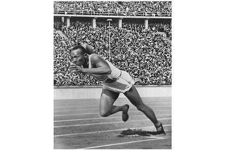 Track sprinter leaving the starting blocks going down the track.