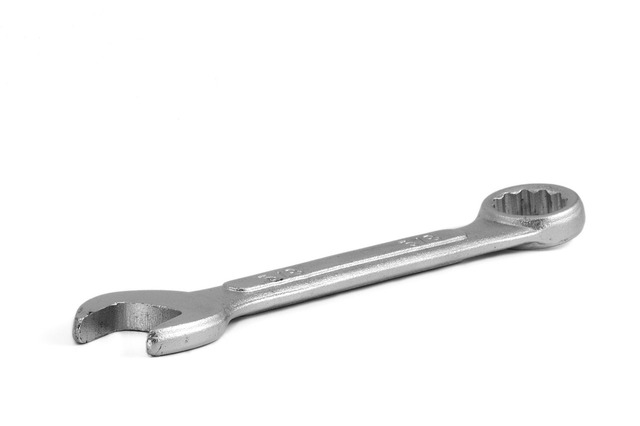 This is an image of a silver wrench in a diagonal position. The end to the lower left is an open end and the end to the upper right is closed end.