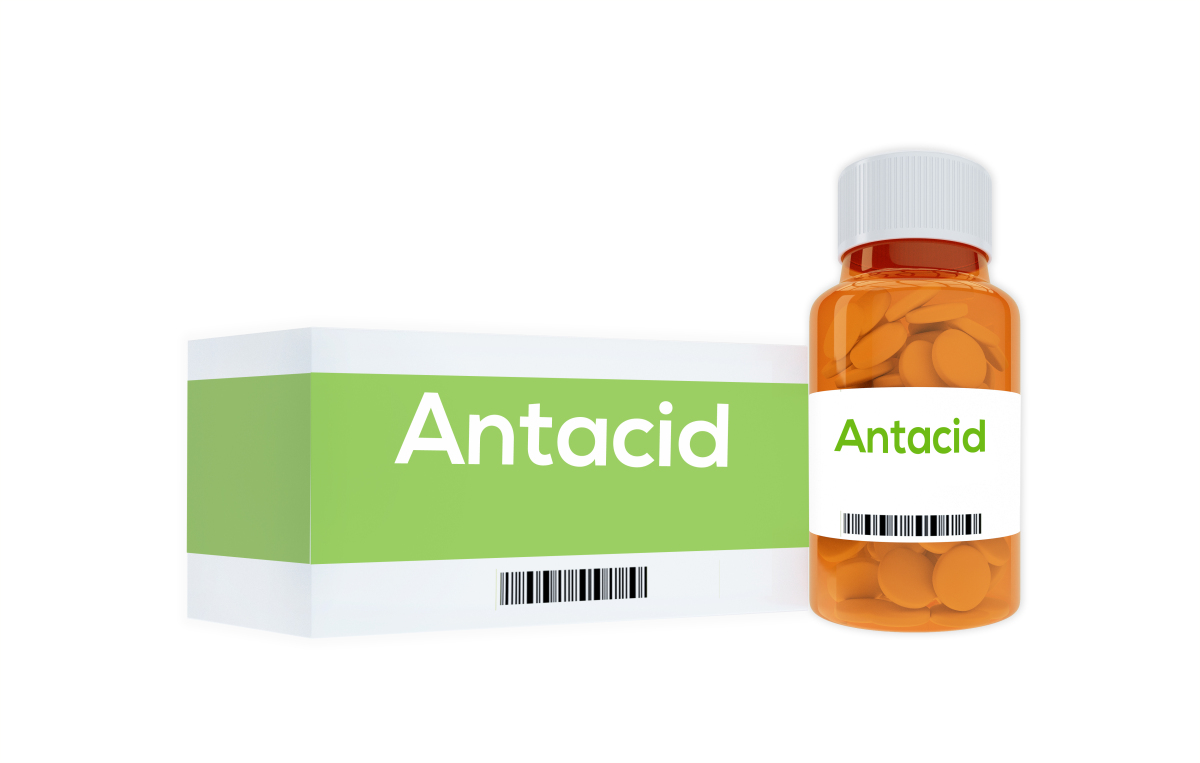 This is an image of a green box with white text that says Antacid with a barcode underneath.  The box is beside a jar of antacid tablets that is orange with a white lid and a white label that reads Antacid.