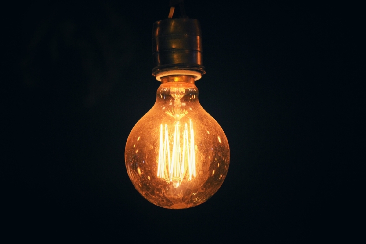 This is an image of glowing Edison-style incandescent light bulb with multiple filaments.