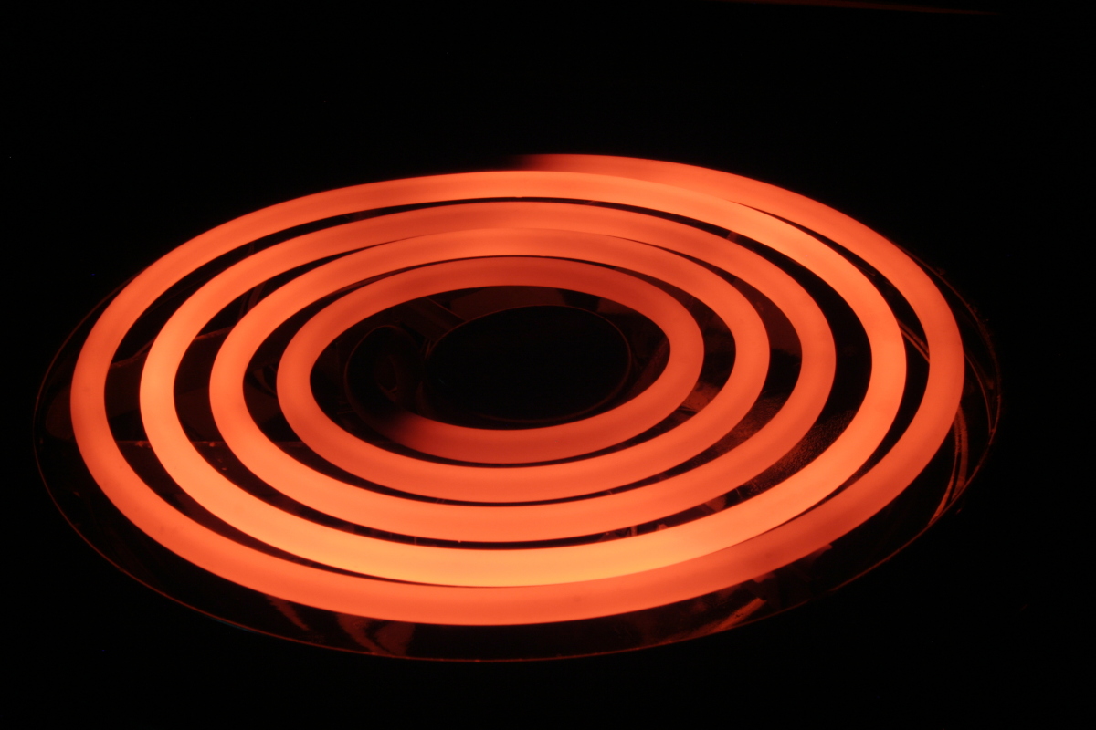 This is an image of an electric stove coil that is glowing red because it is hot.