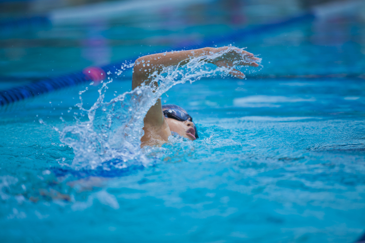 This is an image of a person swimming. Any object in motion, like this person, has kinetic energy.