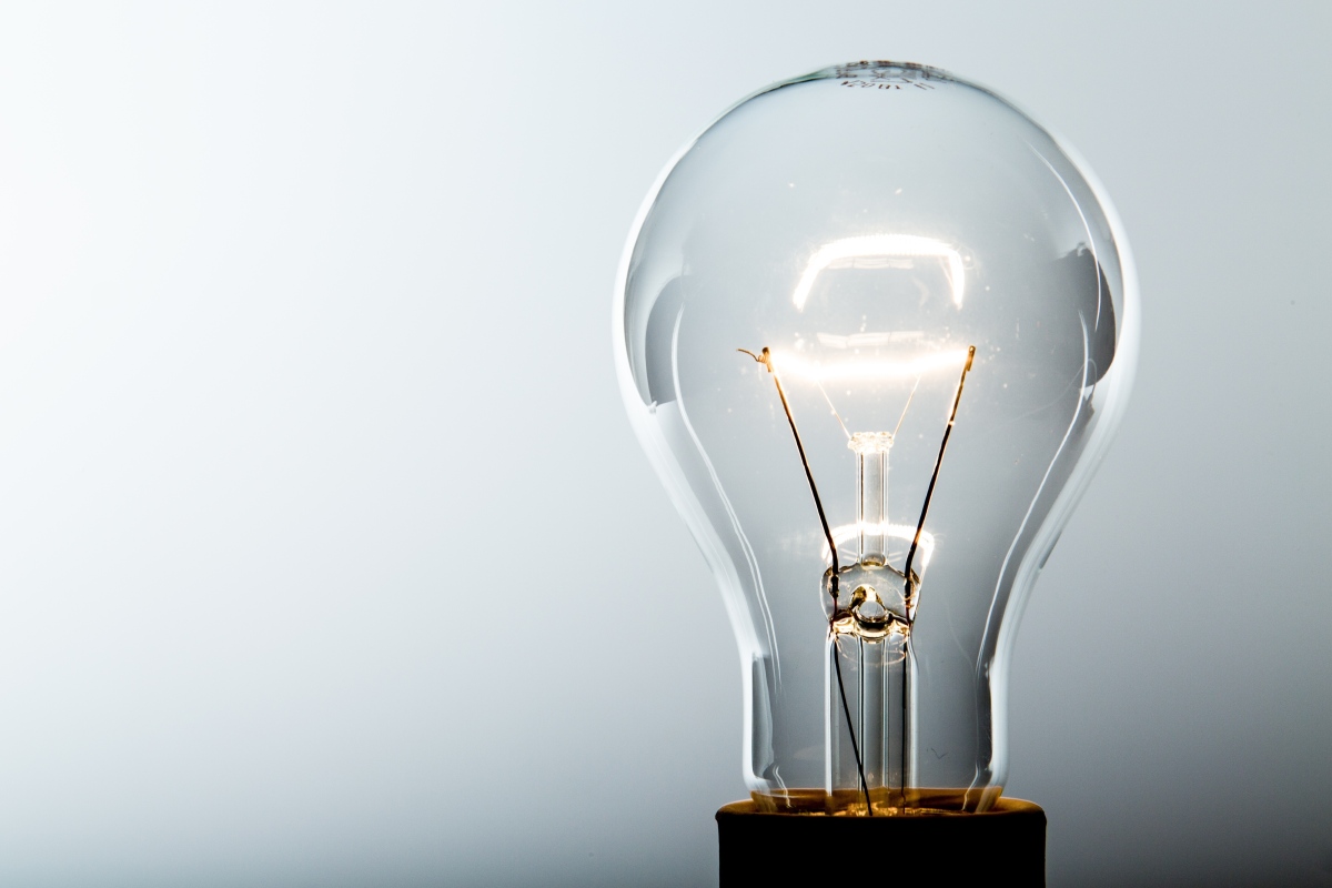 This image depicts an incandescent light bulb with a glowing filament.