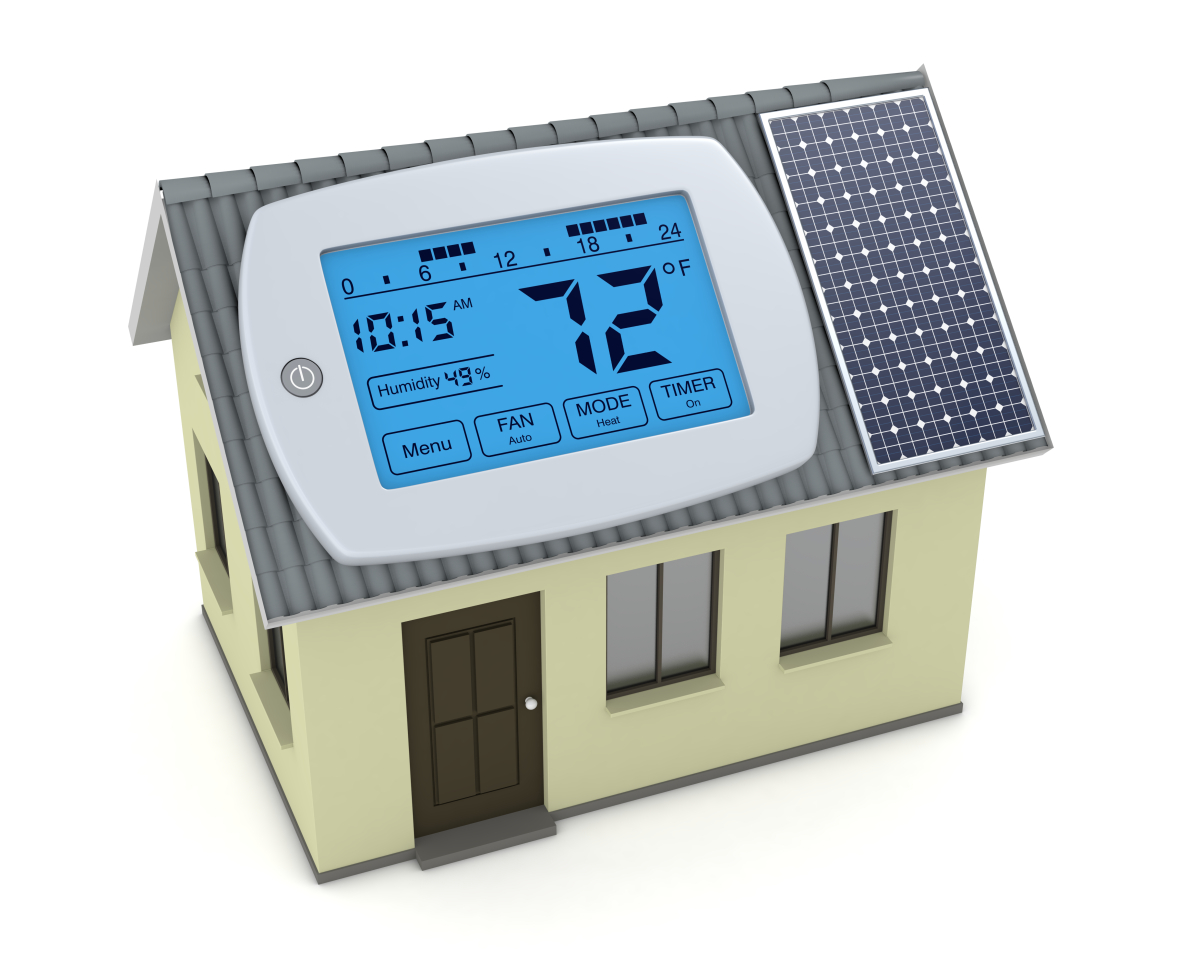 This image depicts a renewable energy concept of a miniature house with a digital programmable thermostat and a solar panel sitting on the roof. 