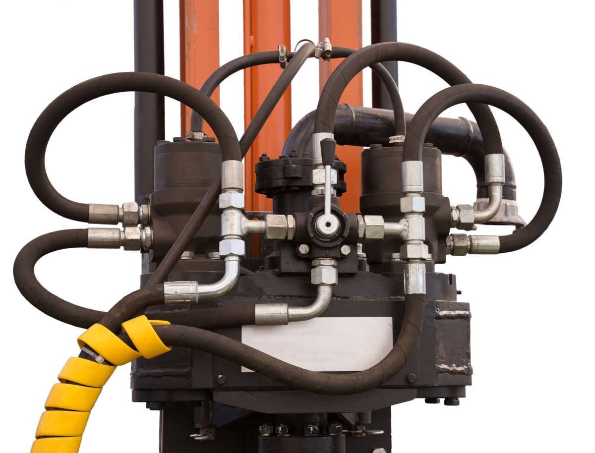 This image depicts a mass of hydraulic transmission lines and fittings.