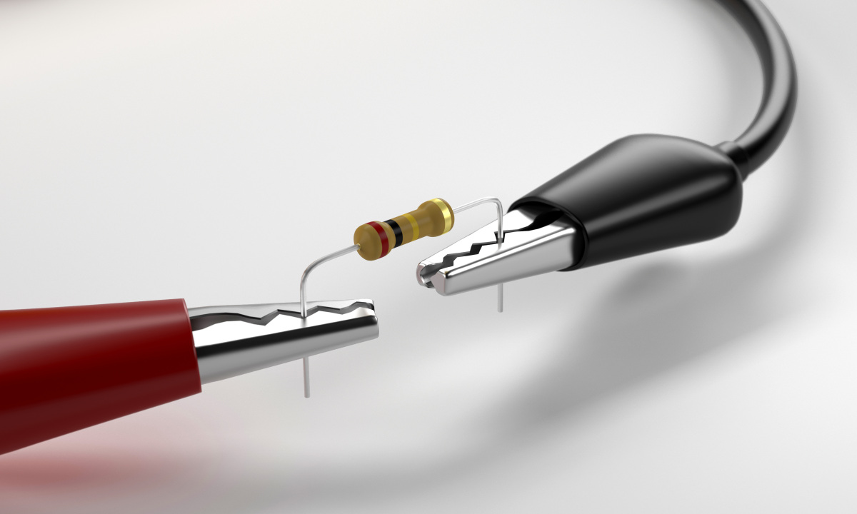 This image depicts a resistor connected to two test clips. 