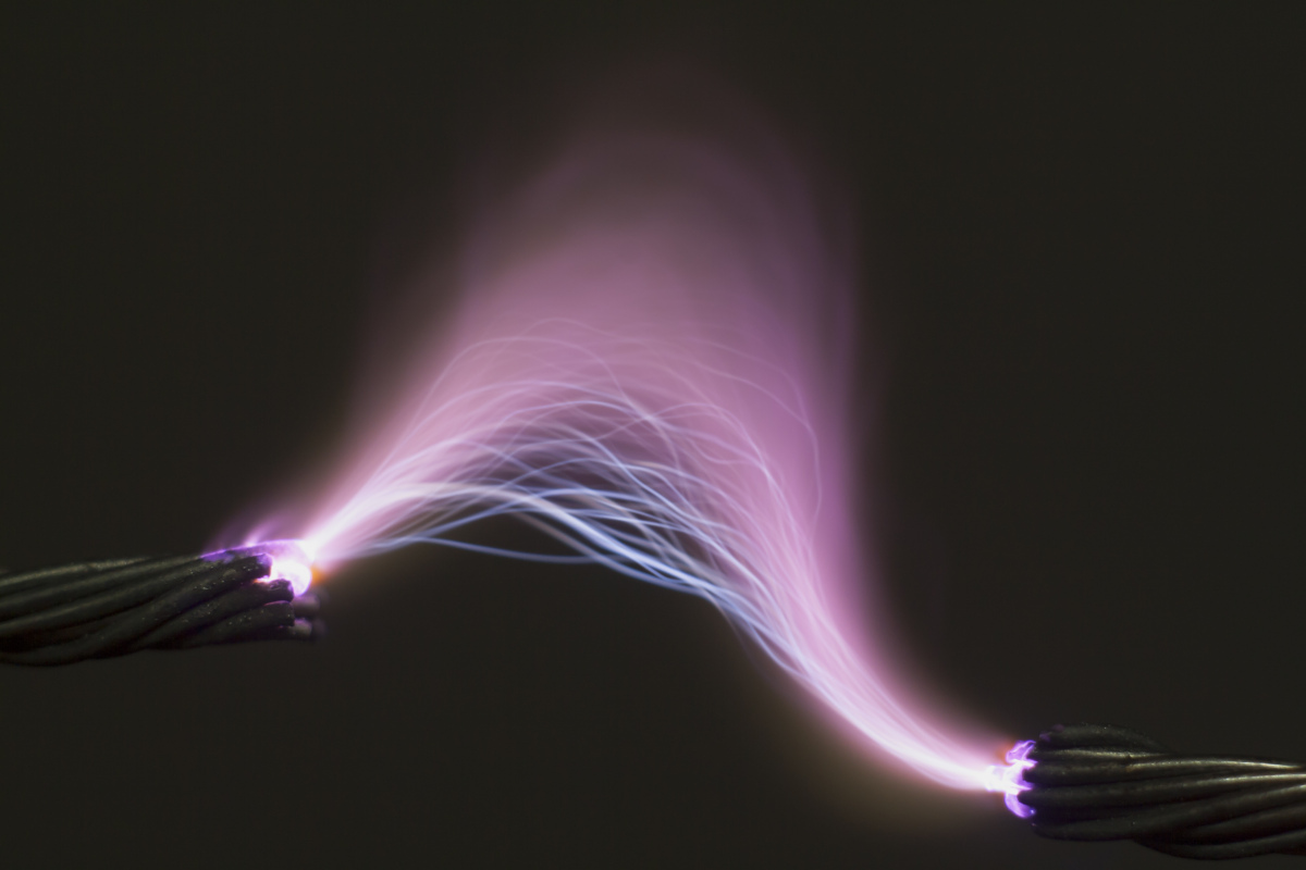 This image depicts a spark between ends of a broken electrical cable.